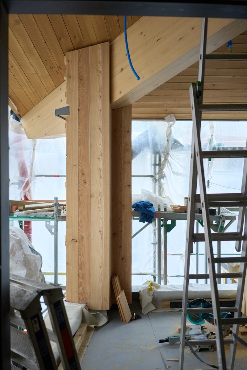 Wooden beams and ceiling in a room under construction.